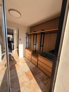 a room with wooden shelves and a room with a hallway at Sexty-nine, villa 69 héliovillage in Cap d'Agde