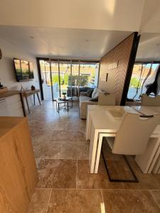 a living room with a couch and a table at Sexty-nine, villa 69 héliovillage in Cap d'Agde