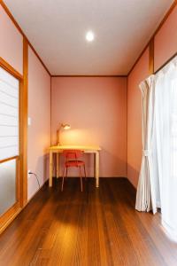 a table in a room with a red wall at WaKaRaN9111 和華蘭文化を体感! 長崎情緒あふれる一軒家 in Nagasaki