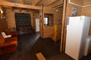 a living room with a couch and a refrigerator at Vila Flora Costinesti in Costinesti