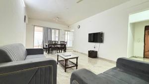 a living room with a couch and a tv at Nestoria Corporate Services in Pune