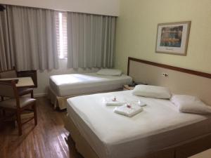 Voodi või voodid majutusasutuse Inter Plaza Hotel toas