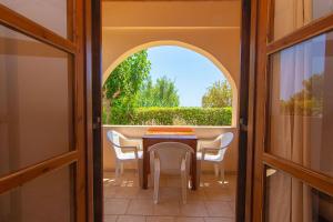 a table and chairs in a room with a window at Aeolos seaside studios in Frangokastello