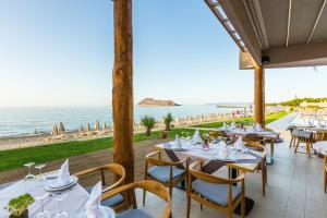 a restaurant with a view of the ocean at Blue Dome Hotel in Platanias