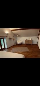 a room with a bed and a couch in a room at Gîte des Charbonneaux in Avrée