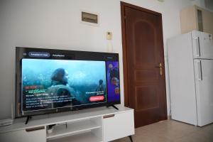 a flat screen tv sitting on top of a white cabinet at Meltemi by GG in Alexandroupoli
