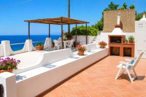 a patio with a table and chairs and a fireplace at Maridea - Vela in Ponza