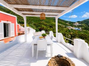 a balcony with a table and chairs on a house at Maridea - Vela in Ponza