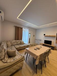 a living room with a couch and a table at Rajan Villas in Vlorë +8 photos