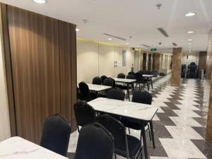 a conference room with tables and chairs in a building at Ritaj Al-Tala'i in Mecca