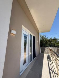 a door on the side of a house at Rajan Villas in Vlorë