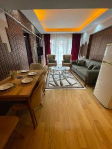 a living room with a table and a couch at Poli House in Kasaplar