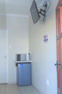 a kitchen with a blue refrigerator and a light at Prax Guest House Benoni in Benoni