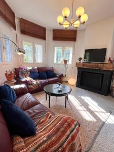 a living room with a couch and a fireplace at Casa Roja Sigüenza in Sigüenza