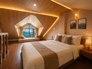 a bedroom with a large bed with a large window at Hotel Hollywood Manali - Scenic River & Mountain View With Premium Rooms Near Mall Road in Manāli