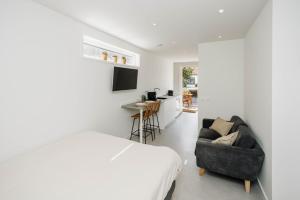 a bedroom with a bed and a chair and a desk at The Dune gate in Zandvoort