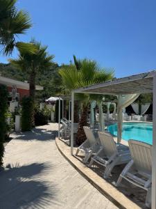 a group of chairs sitting next to a swimming pool at L'oasi del Tuffatore in Agropoli