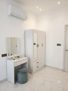 a white bathroom with a sink and a mirror at Faresmaathoda Sunset Stay in Faresmathoda
