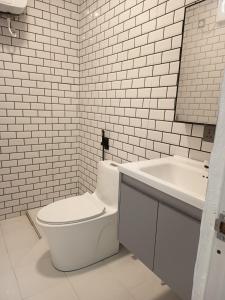 a white bathroom with a toilet and a sink at Faresmaathoda Sunset Stay in Faresmathoda