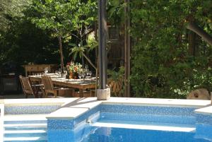 a swimming pool with a table and a table set up with a table at Olive Tree House in Anoyira