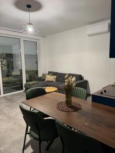 a living room with a table and a couch at BR Tale in Lezhë +7 photos