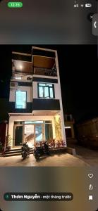 a picture of a house with two motorcycles parked in front at Phố Cổ Villa Ninh Bình in Kỳ Vĩ