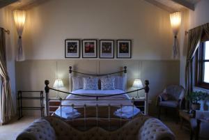 a bedroom with a large bed and two chairs at Olive Tree House in Anoyira +123 photos