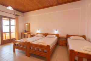 a bedroom with two beds and a window at Aeolos seaside studios in Frangokastello