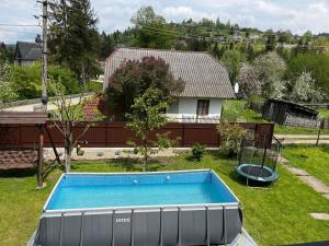 a swimming pool in the yard of a house at Center Cottage Чан in Slavske