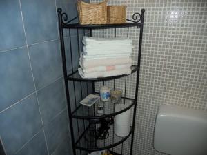 a bathroom with a towel rack next to a toilet at Apartment Milano in Matulji +19 photos