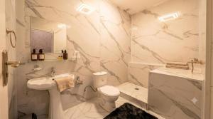 a bathroom with a toilet and a sink at Hotel Usmoon in Tashkent +25 photos