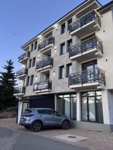 a car parked in front of a building at Monte LUX 10 in Kopaonik