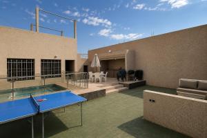 a house with a ping pong table on the patio at Villa privée avec piscine chauffée in Oulad Teïma