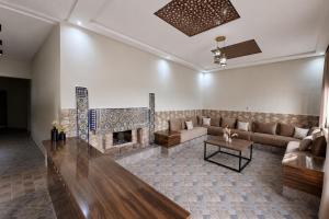 a living room with a couch and a fireplace at Villa privée avec piscine chauffée in Oulad Teïma