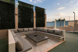 a couch sitting on top of a patio at Villa privée avec piscine chauffée in Oulad Teïma