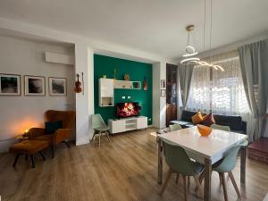 a living room with a table and a fireplace at Rome - Green Hills condominio in Colleverde