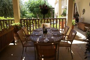 a wooden table and chairs on a patio at Olive Tree House in Anoyira