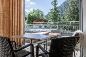 a patio with a table and chairs on a balcony at Arabella Retreat & Spa in Nauders