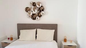 a bedroom with a bed and a clock on the wall at Habita SerpaPinto in Estremoz +34 photos