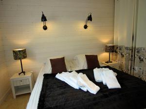 a bedroom with a bed with towels on it at Au Pré Carré in Plumergat +2 photos