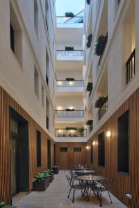 a courtyard with tables and chairs in a building at La Falconeria Hotel in Valletta