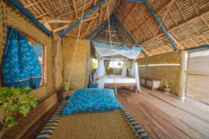 a bedroom with a bed and a hammock in a room at Kizingo Beach Eco Lodge in Lamu +237 photos