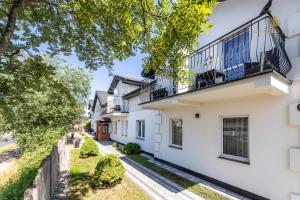 an image of a white house with a balcony at GRAND VILLA USTKA- POKOJE z BALKONAMI I TARASAMI, PARKING W CENIE ! in Ustka
