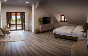 a bedroom with a bed and a television in it at TERRA penzión in Jasová
