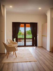 a living room with a chair and a window at TERRA penzión in Jasová