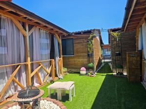a backyard with a lawn with a table and chairs at Royal hammock-Kralski hamak in Chernomorets