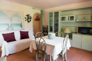 a living room with a table and a couch at Appartamento Monte Ladu in Porto Rotondo