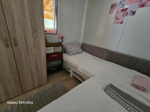 a small room with two beds and a cabinet at Royal hammock-Kralski hamak in Chernomorets
