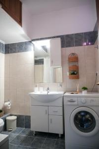 a bathroom with a washing machine and a sink at Meltemi by GG in Alexandroupoli