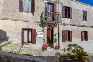 a building with a sign on the side of it at Camere Di Ulisse in Erice